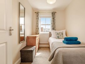 A bedroom with a bed and mirror at Rails End
