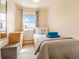 A bedroom with a single bed and dresser at Rails End