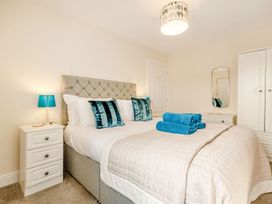 A bedroom with a bed and bedside table at Rails End 