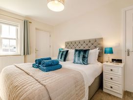 A bedroom with a bed and bedside table at Rails End