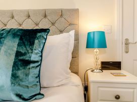 A bedroom with a headboard and nightstand at Rails End