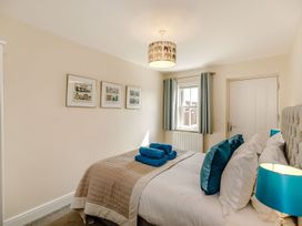 A bedroom with a bed and wall art at Rails End