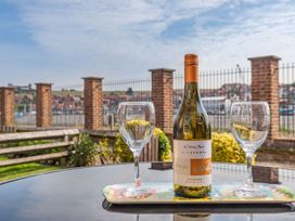 A bottle of wine and glasses on a tray at Rails End