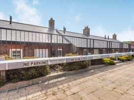 An outdoor view of cottages with a parking area at Rails End Cottage