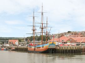 A ship docked at the harbor with buildings in the background at Rails End