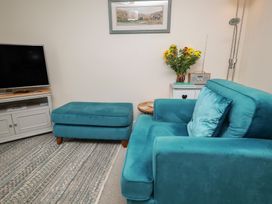 A living room with a couch and television at Rails End in Whitby