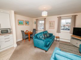 A living room with a sofa and table at Rails End in Whitby