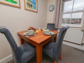 A dining room with a table set for breakfast at Rails End in Whitby