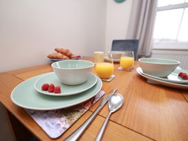 A dining table with bowls and drinks at Rails End in Whitby