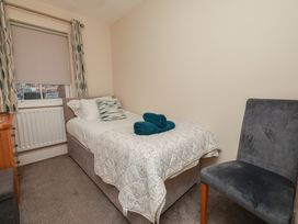 A bedroom with a bed and chair at Rails End in Whitby