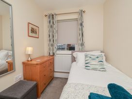 A bedroom with a single bed and dresser at Rails End in Whitby