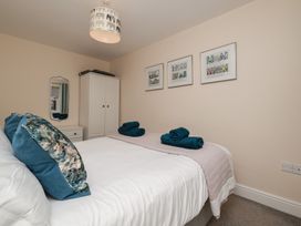A bedroom with a bed and artwork on the wall at Rails End in Whitby
