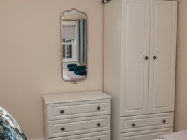 A bedroom with a mirror and a dresser at Rails End in Whitby