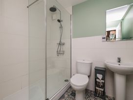 A bathroom with a shower, toilet and sink at Rails End in Whitby