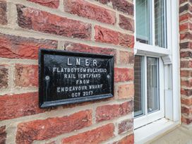 A plaque mounted on a brick wall at Rails End in Whitby