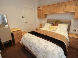 A bedroom with a bed and furniture at Jodene Lodge, Redwood 2 Bowness-On-Windermere