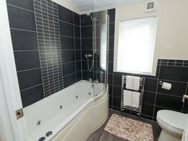 A bathroom with a bathtub and shower at Jodene Lodge, Redwood 2, Bowness-On-Windermere