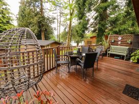 An outdoor area with a deck, table, and chairs at Jodene Lodge, Redwood 2 Bowness-On-Windermere