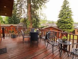 A deck with seating and plants at Jodene Lodge, Redwood 2 Bowness-On-Windermere