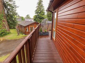 An outdoor deck with a hanging planter at Jodene Lodge, Redwood 2 Bowness-On-Windermere