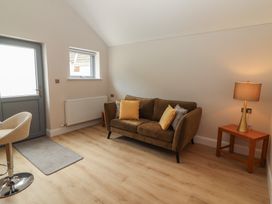 A living room with a sofa and lamp at 17 ROOSKA in Lisdoonvarna, County Clare