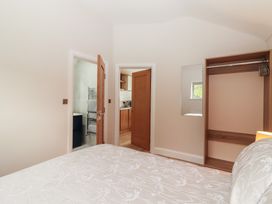 A bedroom with an open door leading to a kitchen at 17 ROOSKA, Lisdoonvarna, County Clare