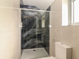 A bathroom with a shower and toilet at 17 ROOSKA, Lisdoonvarna, County Clare