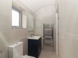 A bathroom with a sink, toilet, and towel radiator at 17 ROOSKA, Lisdoonvarna, County Clare