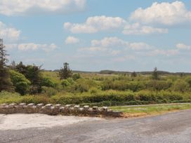 A view of trees and fields with a stone wall at 17 ROOSKA, Lisdoonvarna, County Clare
