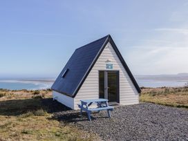 A cabin with a table outside at Cabin 1 Machaire Rabhartaigh in Gortahawk
