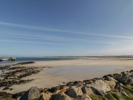 A beach with rocks and a pier at Cabin 1 Machaire Rabhartaigh Gortahawk