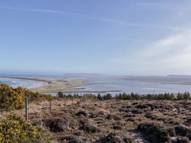 A landscape view of water and land with a fence at Cabin 1 Machaire Rabhartaigh in Gortahawk