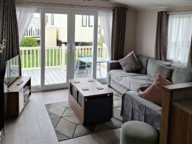 A living room with a sofa and coffee table at Harbour Watch 22 in Watchet