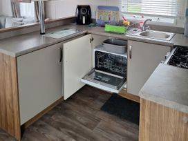 A kitchen with a sink and dishwasher at Harbour Watch 22 Watchet