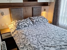 A bedroom with a bed and pillows at Harbour Watch 22 in Watchet