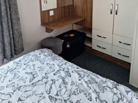A bedroom with a bed and storage in Harbour Watch 22 Watchet