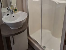 A bathroom with a sink and a shower at Harbour Watch 22 in Watchet