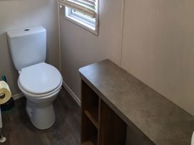A bathroom with a toilet and a counter at Harbour Watch 22 in Watchet