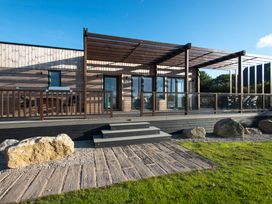 A deck with steps and pergola at Barbara in Portreath