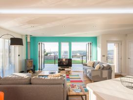 A living room with a television and sofas at Barbara in Portreath