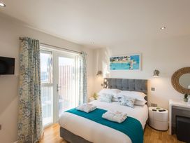 A bedroom with a bed and a television at Barbara in Portreath