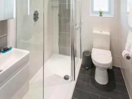 A bathroom with a shower, toilet, and sink at Barbara in Portreath