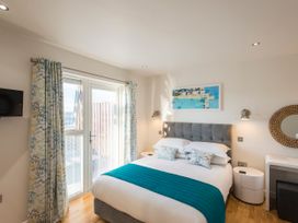 A bedroom with a bed and window at Barbara in Portreath