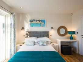 A bedroom with a bed and decorative items at Barbara in Portreath