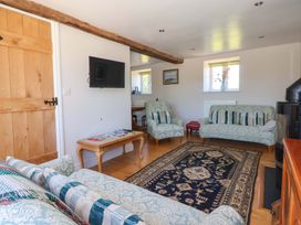 A living room with sofas and a television at The Annexe at Dalby Carr