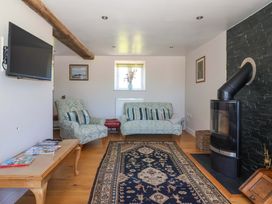 A living room with a sofa and TV at The Annexe at Dalby Carr