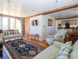 A living room with sofa and dining table at The Annexe at Dalby Carr 