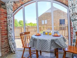 A dining area with a table and chairs at The Annexe at Dalby Carr