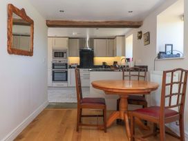 A kitchen with a dining table and chairs at The Annexe at Dalby Carr