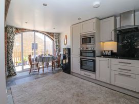 A kitchen with a table and chairs at The Annexe at Dalby Carr